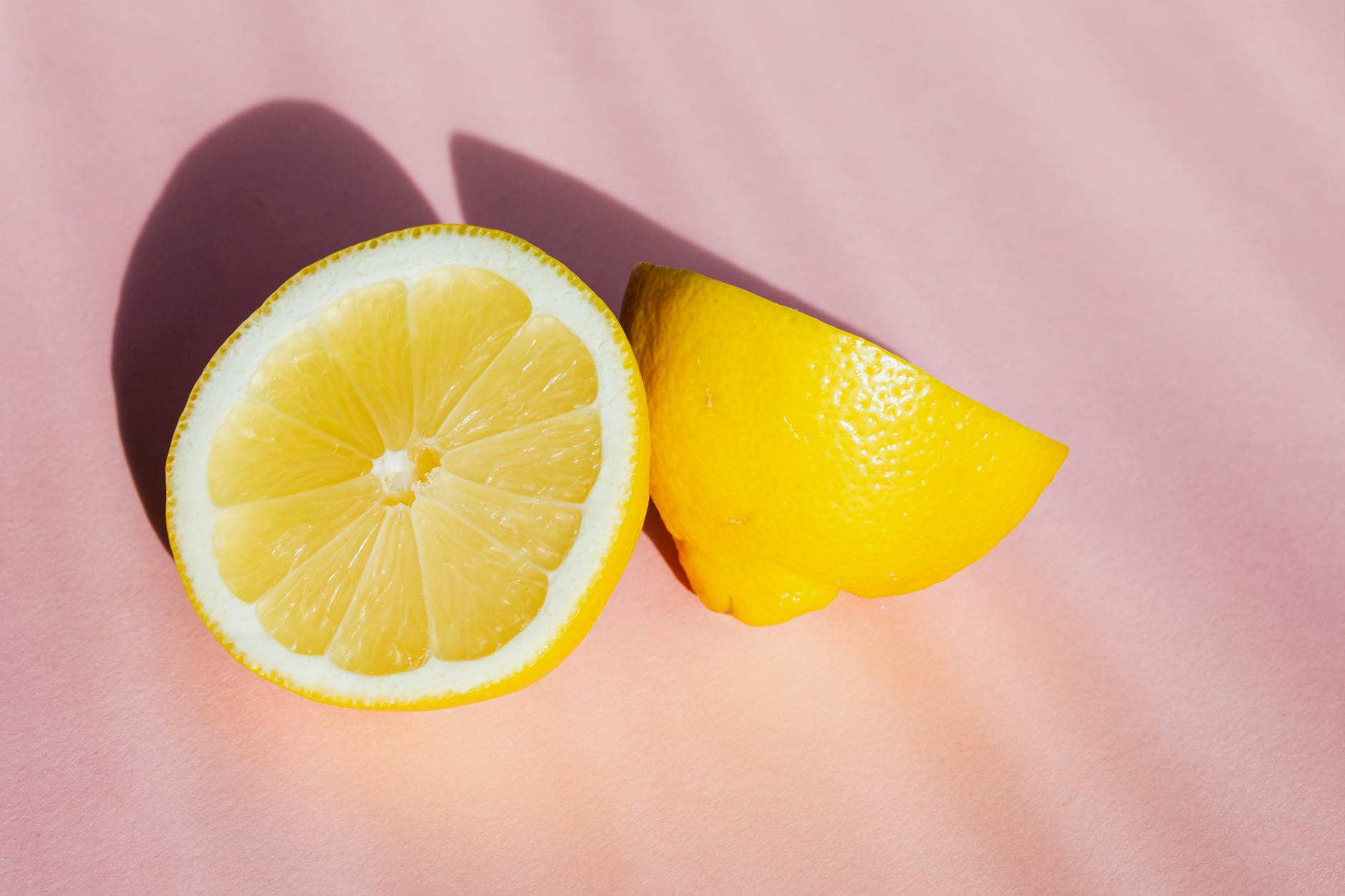 A pregnant person holding a fresh lemon, symbolizing natural vitality and sensory change during pregnancy