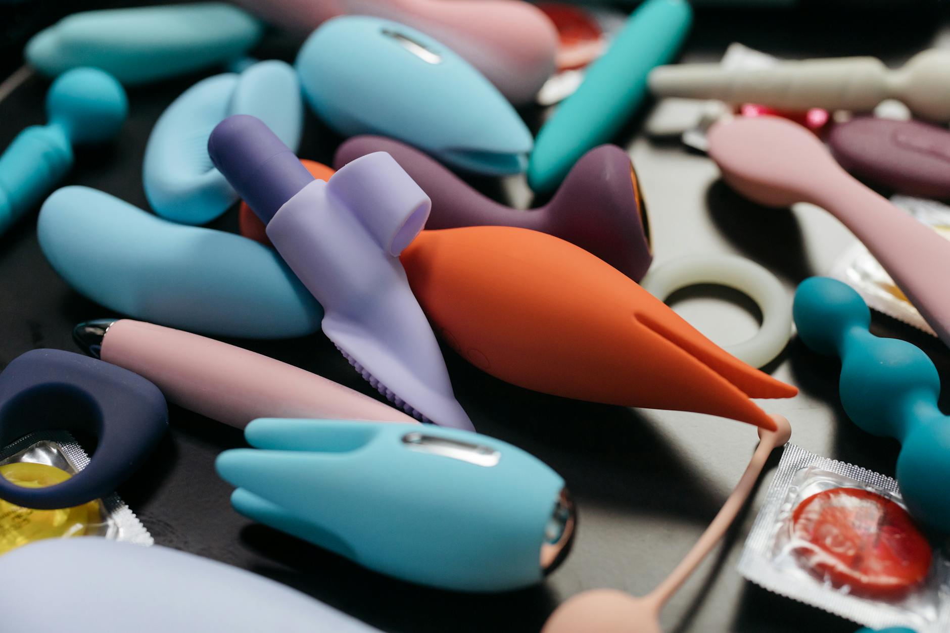 An array of vibrant clitoral vibrators and toys displayed close-up
